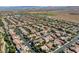Expansive aerial view of a residential neighborhood with neatly lined homes and desert landscape at 9950 Waxberry Ct, Las Vegas, NV 89178