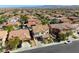Wide aerial shot of a residential neighborhood featuring homes with tile roofs and well-kept yards at 9950 Waxberry Ct, Las Vegas, NV 89178