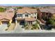 Aerial view of a home showcasing its tile roof, landscaping, and proximity to neighboring houses at 9950 Waxberry Ct, Las Vegas, NV 89178