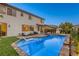 Inviting backyard with pool, hot tub, and outdoor seating area, perfect for relaxation and entertainment at 9950 Waxberry Ct, Las Vegas, NV 89178