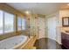The luxurious main bath includes a walk-in shower, tub, dual sinks, and tile accent walls at 9950 Waxberry Ct, Las Vegas, NV 89178
