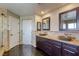 The well-appointed main bath features dual sinks, stone countertops, and a walk-in shower at 9950 Waxberry Ct, Las Vegas, NV 89178