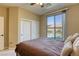 Comfortable bedroom featuring a sliding glass door with backyard and pool views and a large closet at 9950 Waxberry Ct, Las Vegas, NV 89178