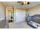 Bright Bedroom showcasing a crib, dresser, and access to an en-suite bathroom, offering convenience at 9950 Waxberry Ct, Las Vegas, NV 89178