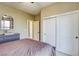 Bedroom with sliding closet doors, neutral walls, carpet flooring, and a view into the hallway at 9950 Waxberry Ct, Las Vegas, NV 89178
