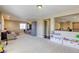 Large bonus room featuring plush carpet, built-in storage, and great natural lighting at 9950 Waxberry Ct, Las Vegas, NV 89178