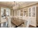 Elegant dining room featuring a stylish chandelier, a dining table with tufted chairs, and custom built-in cabinets at 9950 Waxberry Ct, Las Vegas, NV 89178