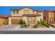 Attractive home exterior featuring a well-maintained yard and a two-car garage in a residential neighborhood at 9950 Waxberry Ct, Las Vegas, NV 89178