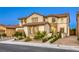 Beautiful two-story home with a tile roof, stone accents, and manicured landscaping at 9950 Waxberry Ct, Las Vegas, NV 89178