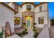 Charming home exterior with stone accents, a landscaped walkway, and a welcoming front door at 9950 Waxberry Ct, Las Vegas, NV 89178