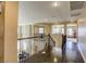 Spacious upstairs hallway with dark wood floors and wrought iron railing, overlooking the lower level at 9950 Waxberry Ct, Las Vegas, NV 89178