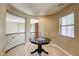 Inviting hallway featuring a decorative table, plush carpeting, and natural light from a window at 9950 Waxberry Ct, Las Vegas, NV 89178