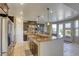 Open-concept kitchen featuring a large island, granite countertops, stainless steel appliances, and ample cabinet space at 9950 Waxberry Ct, Las Vegas, NV 89178