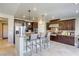 Gourmet kitchen with island, breakfast bar, stainless appliances, and custom cabinetry for a modern, functional design at 9950 Waxberry Ct, Las Vegas, NV 89178