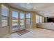 Living room with a view of the backyard pool and spa from the patio doors, neutral colors, and travertine flooring at 9950 Waxberry Ct, Las Vegas, NV 89178