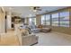 Inviting living room open to kitchen and backyard, featuring a comfortable sectional and bright windows at 9950 Waxberry Ct, Las Vegas, NV 89178