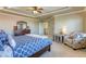 Large main bedroom with sitting area, ceiling fan, and entry to the attached main bath at 9950 Waxberry Ct, Las Vegas, NV 89178