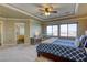 Large main bedroom features a tray ceiling, ceiling fan, and sitting area by the windows at 9950 Waxberry Ct, Las Vegas, NV 89178