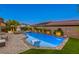 Sparkling pool and spa area with stone accents and lush landscaping, creating a private oasis at 9950 Waxberry Ct, Las Vegas, NV 89178