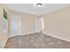 An empty bedroom with tile flooring, neutral walls, and white doors at 100 Ocotillo St, Henderson, NV 89015