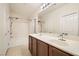 Bathroom with double sink vanity and shower over tub at 10147 Aspen Rose St # 101, Las Vegas, NV 89183