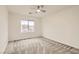 Bedroom with carpet floors, ceiling fan, and a large window at 10147 Aspen Rose St # 101, Las Vegas, NV 89183
