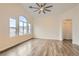 Spacious living room featuring vaulted ceilings, wood floors, and large windows at 10147 Aspen Rose St # 101, Las Vegas, NV 89183