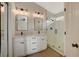 Modern bathroom with double sinks, a glass shower, and updated lighting fixtures at 1107 Cloudy Day Dr, Henderson, NV 89074