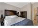 Bedroom showcasing a wooden headboard and an accompanying wood dresser and mirror at 1107 Cloudy Day Dr, Henderson, NV 89074