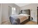 Comfortable bedroom featuring a large window, neutral tones, and stylish furnishings at 1107 Cloudy Day Dr, Henderson, NV 89074
