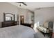 Bedroom features a comfy sitting chair, dresser, and neutral paint at 1107 Cloudy Day Dr, Henderson, NV 89074