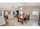 Bright, open-concept living space with vaulted ceilings, a fireplace, and a stylish dining area with a wood table at 1107 Cloudy Day Dr, Henderson, NV 89074