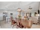 This home's open layout showcases a dining room with wood table, seamlessly connecting to a modern kitchen at 1107 Cloudy Day Dr, Henderson, NV 89074