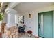 Charming entryway with a teal front door, stone pillars and a cozy seating area at 1107 Cloudy Day Dr, Henderson, NV 89074