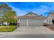 Charming home featuring a spacious two-car garage with stone accents and a well-maintained front yard at 1107 Cloudy Day Dr, Henderson, NV 89074