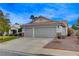 Charming single-story home featuring a spacious two-car garage and low maintenance landscaping at 1107 Cloudy Day Dr, Henderson, NV 89074
