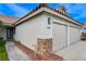 Close up of garage with stone detail on a home with a terra cotta colored roof at 1107 Cloudy Day Dr, Henderson, NV 89074