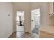 Hallway view of the bedroom and bathroom with wood floors and neutral walls at 1107 Cloudy Day Dr, Henderson, NV 89074
