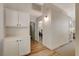 Hallway with wood floors, neutral paint, white cabinets and recessed lighting at 1107 Cloudy Day Dr, Henderson, NV 89074