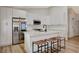 Stylish kitchen with white cabinets, a stainless steel refrigerator, an island with seating, and modern appliances at 1107 Cloudy Day Dr, Henderson, NV 89074
