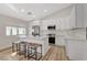 Modern kitchen boasts white cabinets, stainless steel appliances, a center island with seating, and ample counter space at 1107 Cloudy Day Dr, Henderson, NV 89074