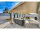 Covered patio area with comfortable seating and a dining set for outdoor enjoyment at 1107 Cloudy Day Dr, Henderson, NV 89074