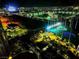 Brightly lit nighttime aerial view of a Topgolf facility with the Las Vegas strip in the background at 135 E Harmon Ave # 2120, Las Vegas, NV 89109