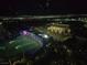 Topgolf Las Vegas at night, featuring illuminated targets, stadium seating, and the lights of the city skyline beyond at 135 E Harmon Ave # 2120, Las Vegas, NV 89109