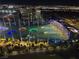 Scenic night view overlooking Topgolf Las Vegas, showcasing colorful targets against the backdrop of the vibrant city lights at 135 E Harmon Ave # 2120, Las Vegas, NV 89109