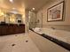 Elegant bathroom featuring a tub, glass shower, vanity and decorative mirrors create a spa-like experience at 135 E Harmon Ave # 2120, Las Vegas, NV 89109