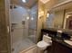 Modern bathroom featuring a glass-enclosed shower, toilet, and a sink vanity with a decorative mirror at 135 E Harmon Ave # 2120, Las Vegas, NV 89109