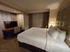 Comfortable bedroom with a plush king-size bed, desk area, and stylish curtains creating a warm atmosphere at 135 E Harmon Ave # 2120, Las Vegas, NV 89109