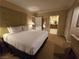 Bright bedroom showcases a king bed and doorway that leads to an ensuite bathroom for added convenience at 135 E Harmon Ave # 2120, Las Vegas, NV 89109