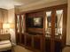 Elegant built-in storage with mirrored accents houses a TV and adds sophistication to the living space at 135 E Harmon Ave # 2120, Las Vegas, NV 89109